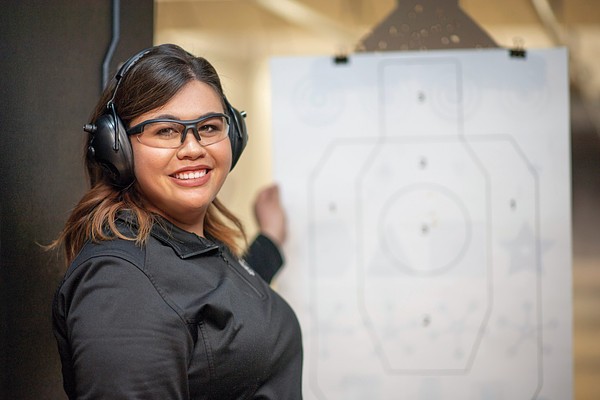 Instructor speaking with a student about handgun safety